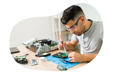 A computer repair technician fixing computer parts.