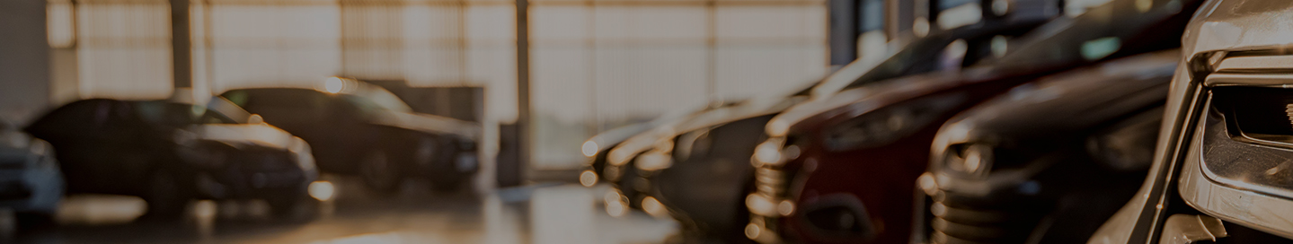 New cars on display in a dealership's showroom.