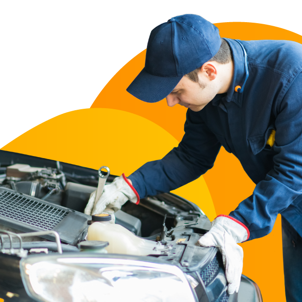 A mechanic works under the hood of a customer's car.