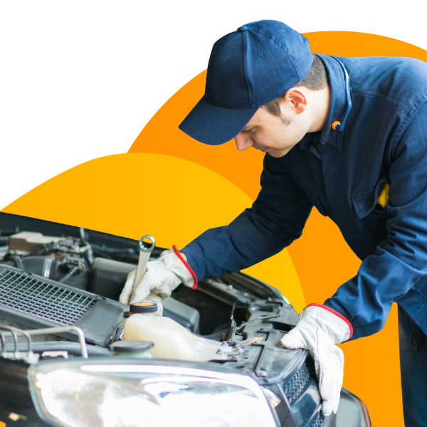 A mechanic works under the hood of a customer's car.