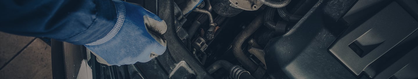 A mechanic working on a customer's vehicle. A mechanic working on a customer's vehicle.