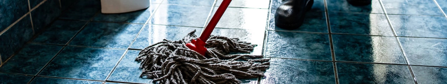A janitor mopping an office floor A janitor mopping an office floor