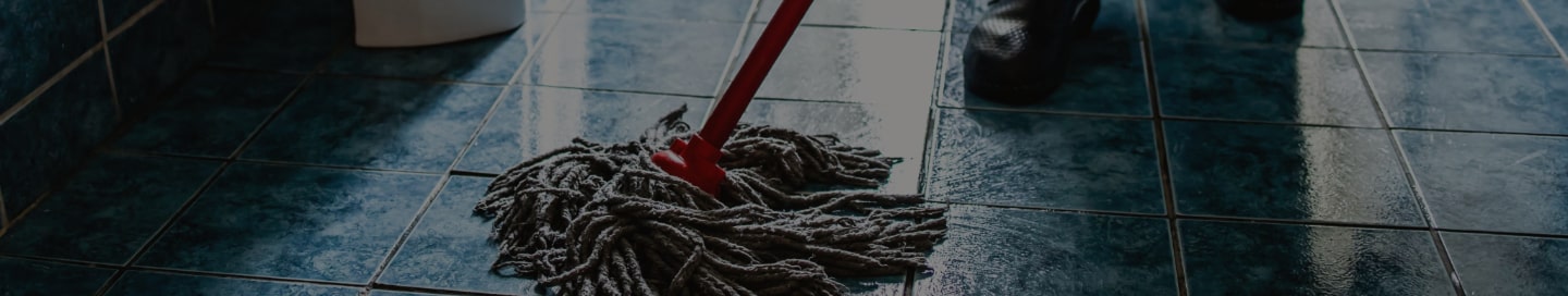 A janitor mopping an office floor A janitor mopping an office floor