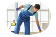 A janitor mopping the floors of a client's office.