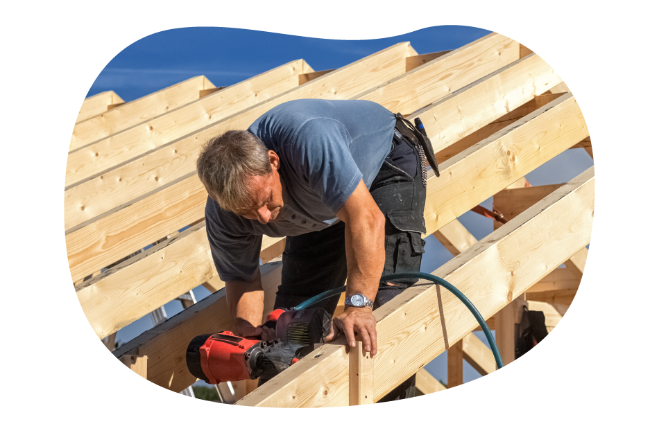 A carpenter building a roof for a client project A carpenter building a roof for a client project
