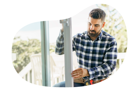 An installer adjusting a new door installation.