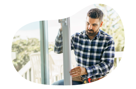 An installer adjusting a new door installation. An installer adjusting a new door installation.