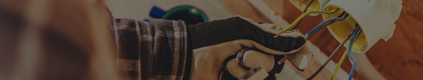 Electrician running wires through conduit.