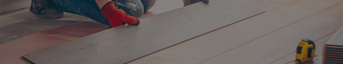 Flooring contractor installing vinyl wood planks.