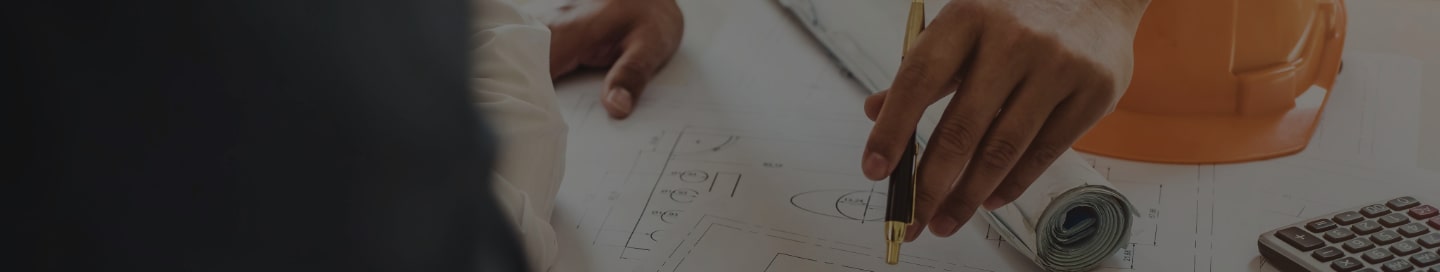 A general contractor mapping out their construction plan with a subcontractor.