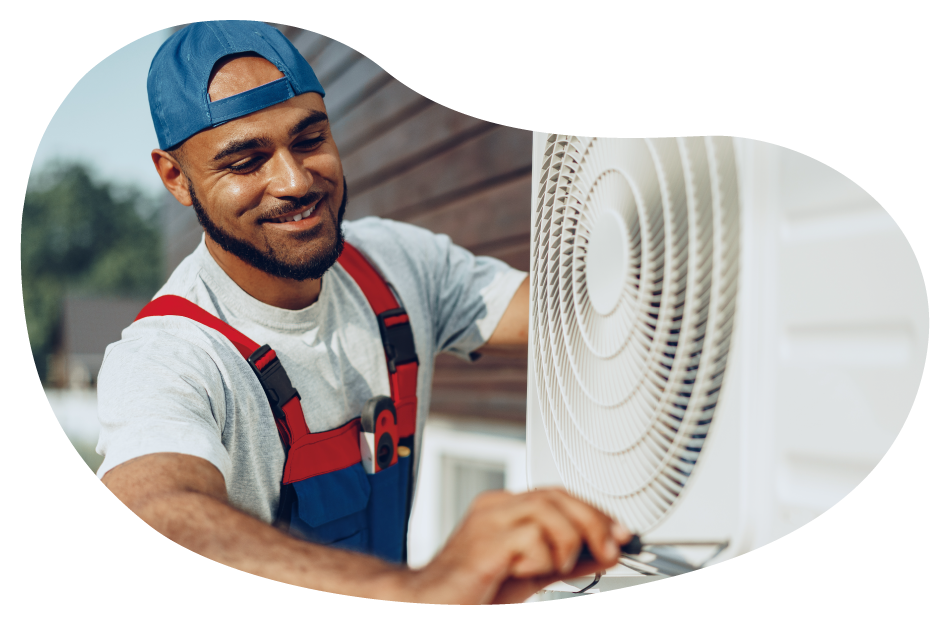 An HVAC contractor working on an AC unit for a customer