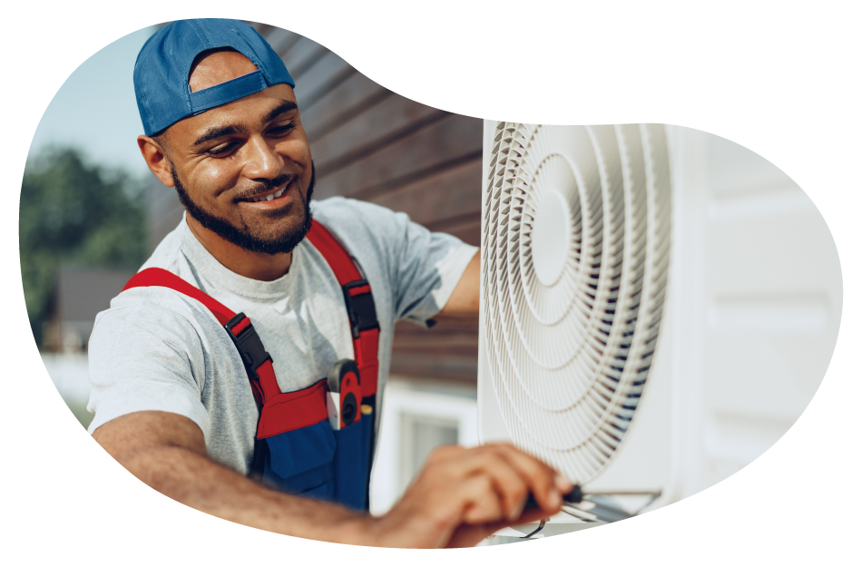 An HVAC contractor working on an AC unit for a customer An HVAC contractor working on an AC unit for a customer