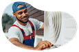 An HVAC contractor working on an AC unit for a customer