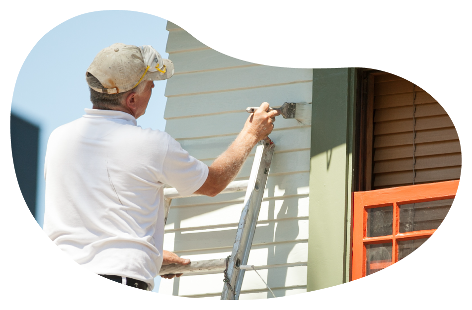 Painter applying a coat of paint onto an exterior wall. Painter applying a coat of paint onto an exterior wall.