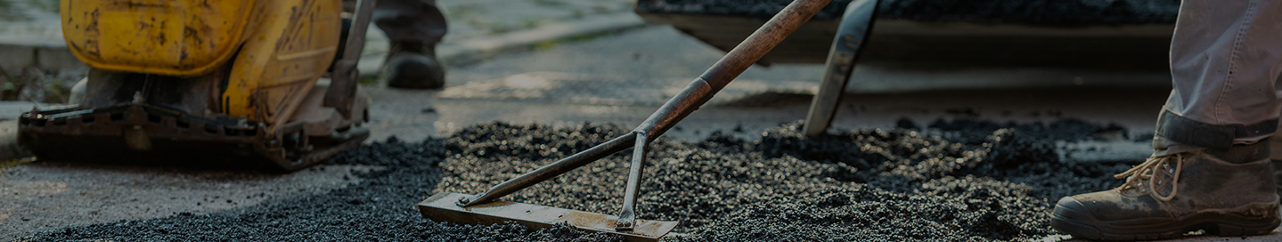 A paving contractor spreading asphalt.