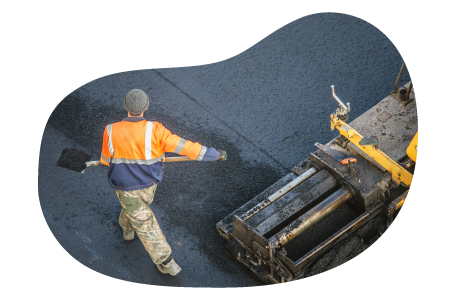 A paving contractor spreading asphalt. A paving contractor spreading asphalt.