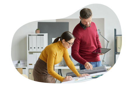 Two architects working on a blueprint for their latest project