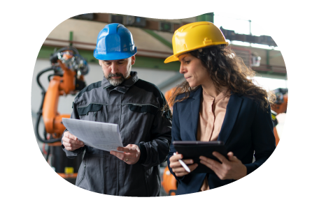 Two engineers check project notes before starting on a client project Two engineers check project notes before starting on a client project