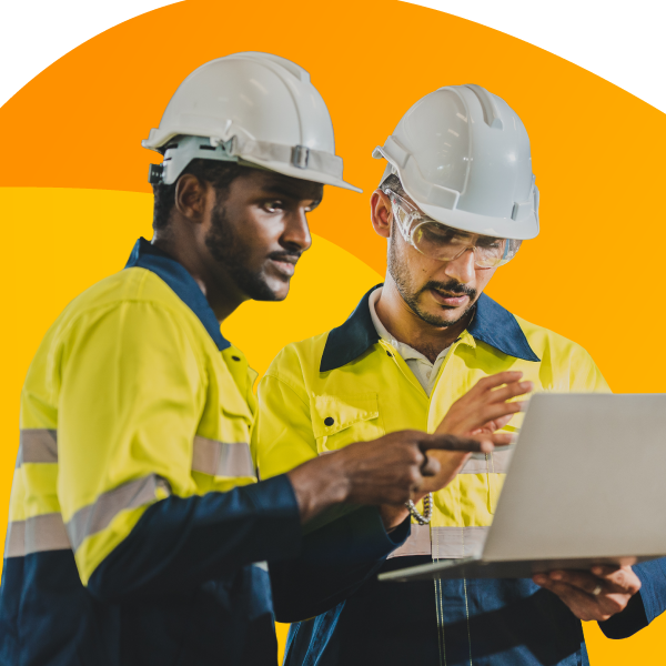 Two engineers checking project plans on a laptop