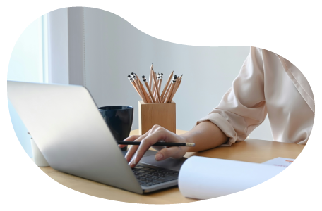 A building designer calculating insurance costs on a laptop.