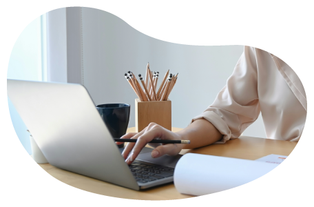 A building designer calculating insurance costs on a laptop. A building designer calculating insurance costs on a laptop.
