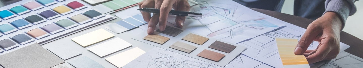 An interior designer reviewing swatches of materials. An interior designer reviewing swatches of materials.