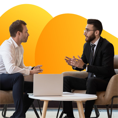 Two businessmen sitting down having a discussion.