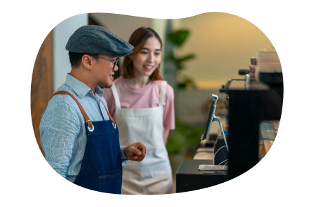 Coffee shop employees at espresso machine