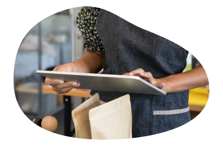 A restaurant owner calculates insurance costs on a tablet. A restaurant owner calculates insurance costs on a tablet.