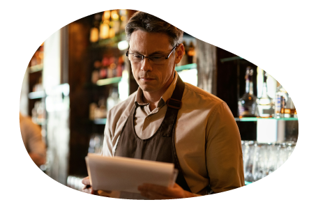 A restaurant owner looks over documents.