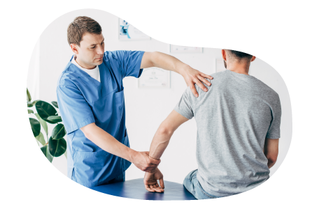 A chiropractor works on a patient's arm and shoulder. A chiropractor works on a patient's arm and shoulder.