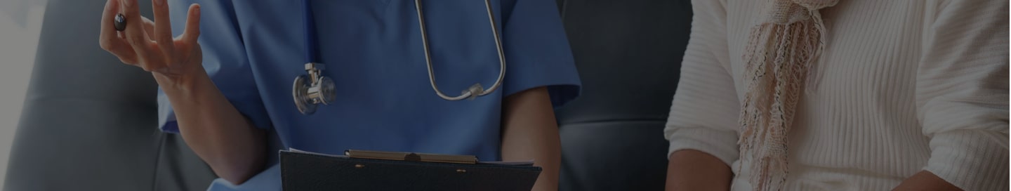 A home healthcare provider speaking with a patient. A home healthcare provider speaking with a patient.