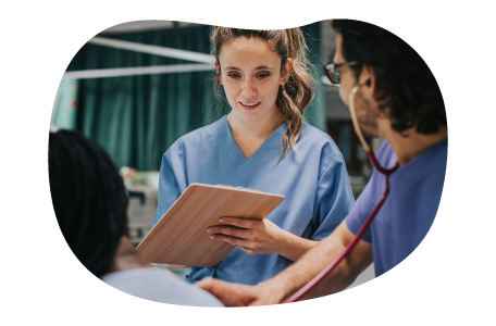 Nurses discussing a patient's chart. Nurses discussing a patient's chart.