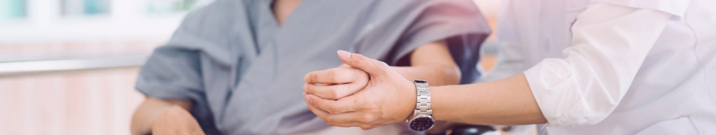 An occupational therapist works with an injured patient during a treatment session