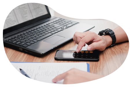 An IT professional calculates insurance costs using a smartphone and clipboard. An IT professional calculates insurance costs using a smartphone and clipboard.
