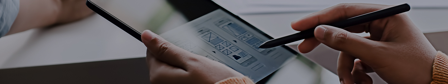 Mobile app developers sketching a prototype on paper and on a tablet.