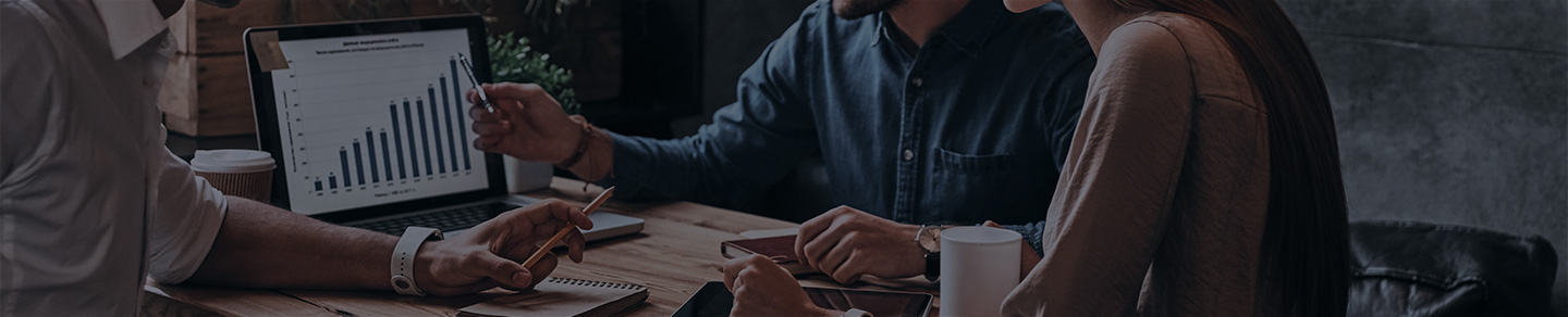 Business people look over stats in a meeting.