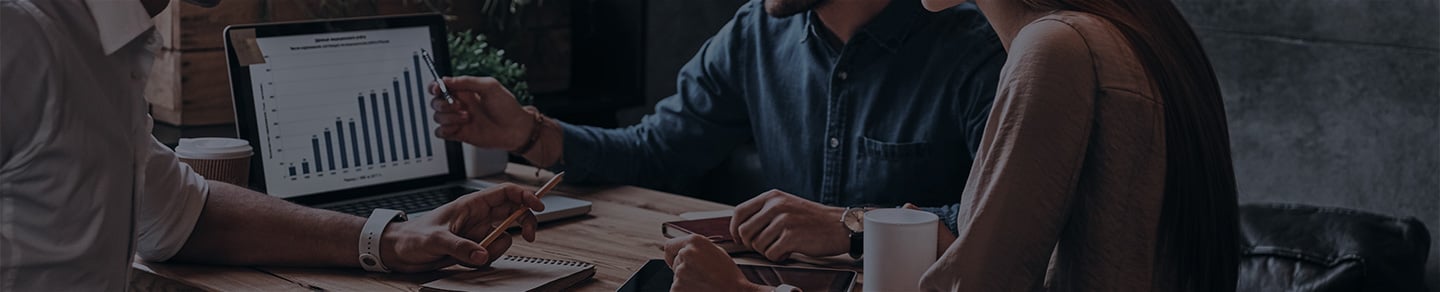 Business people look over stats in a meeting. Business people look over stats in a meeting.