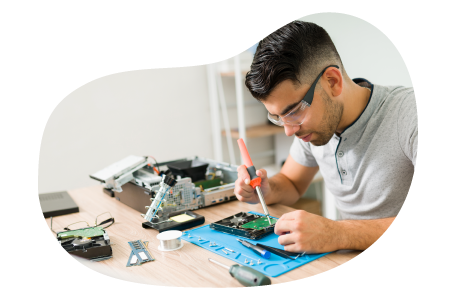 A computer repair technician fixing computer parts.