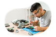 A computer repair technician fixing computer parts.