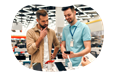 Computer store employee showing smartphones to a customer.