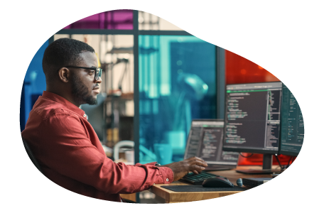 Data architect reviewing programming code on a computer.
