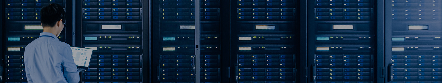 An employee working in a data center's server room.