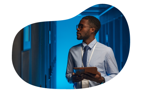 An employee working in a data center's server room.