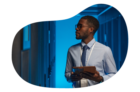 An employee working in a data center's server room. An employee working in a data center's server room.