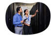 Employees working in a data center's server room.