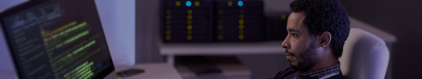 Data scientist at desk working at a computer.