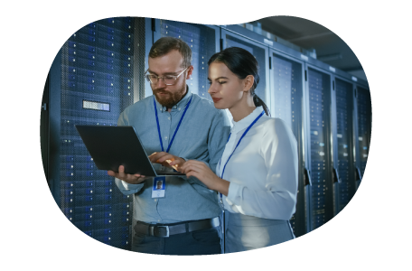 Database administrators evaluating files together on a laptop.