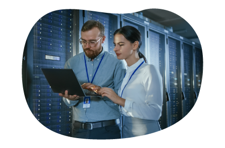 Database administrators evaluating files together on a laptop. Database administrators evaluating files together on a laptop.