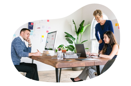 Digital marketers reviewing a project plan in an office. Digital marketers reviewing a project plan in an office.